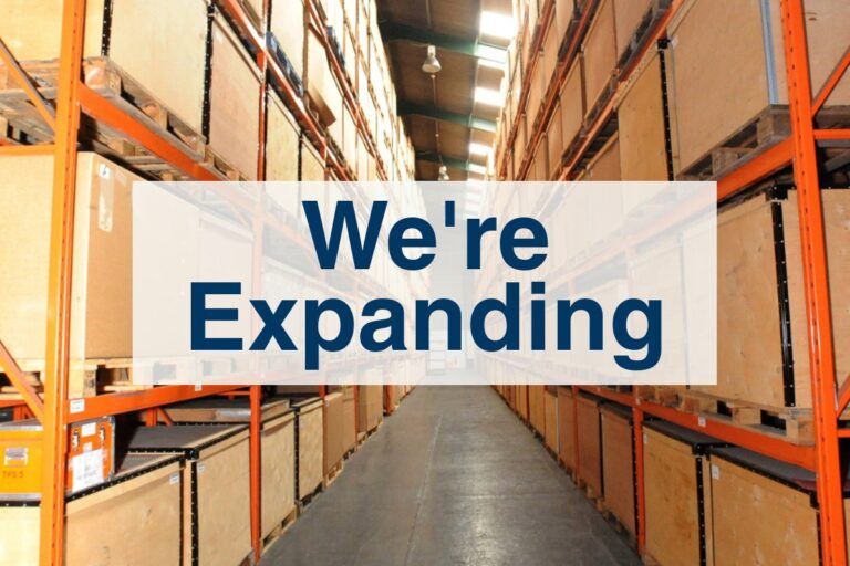 PalStore Warehouse aisle of boxes with text "We're Expanding"